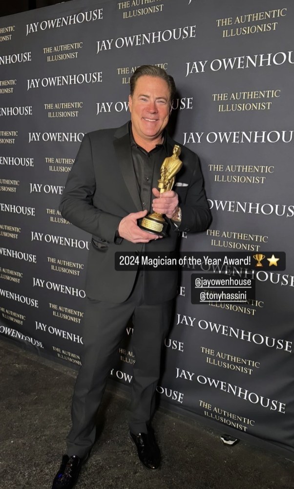 Jay holding his 2024 Magician of the Year trophy