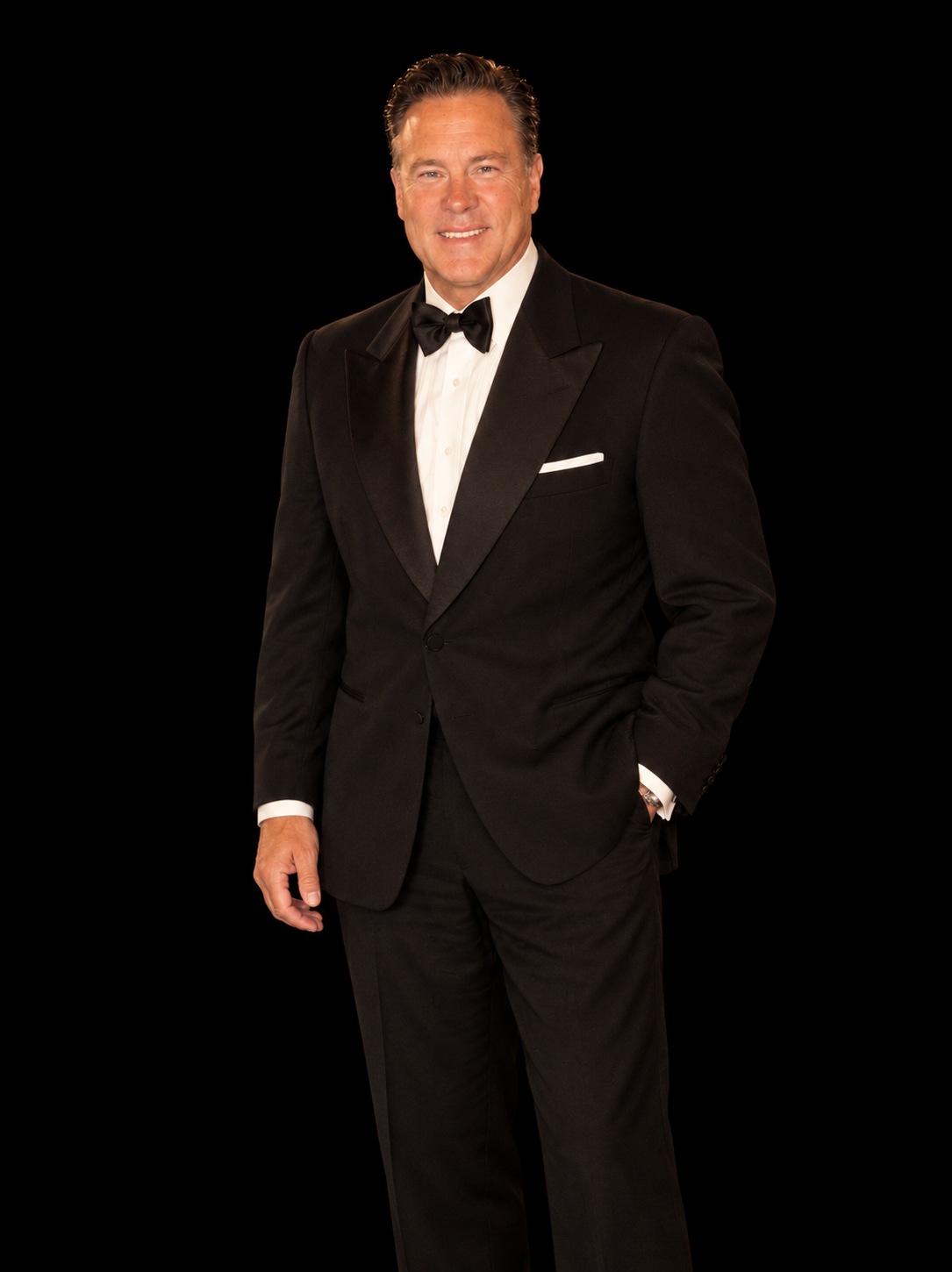 Jay Owenhouse smiling in a black tuxedo