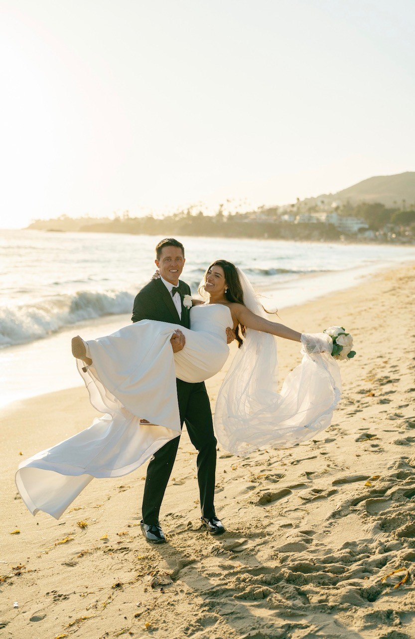 Peter and Gala celebrating their wedding on the beach