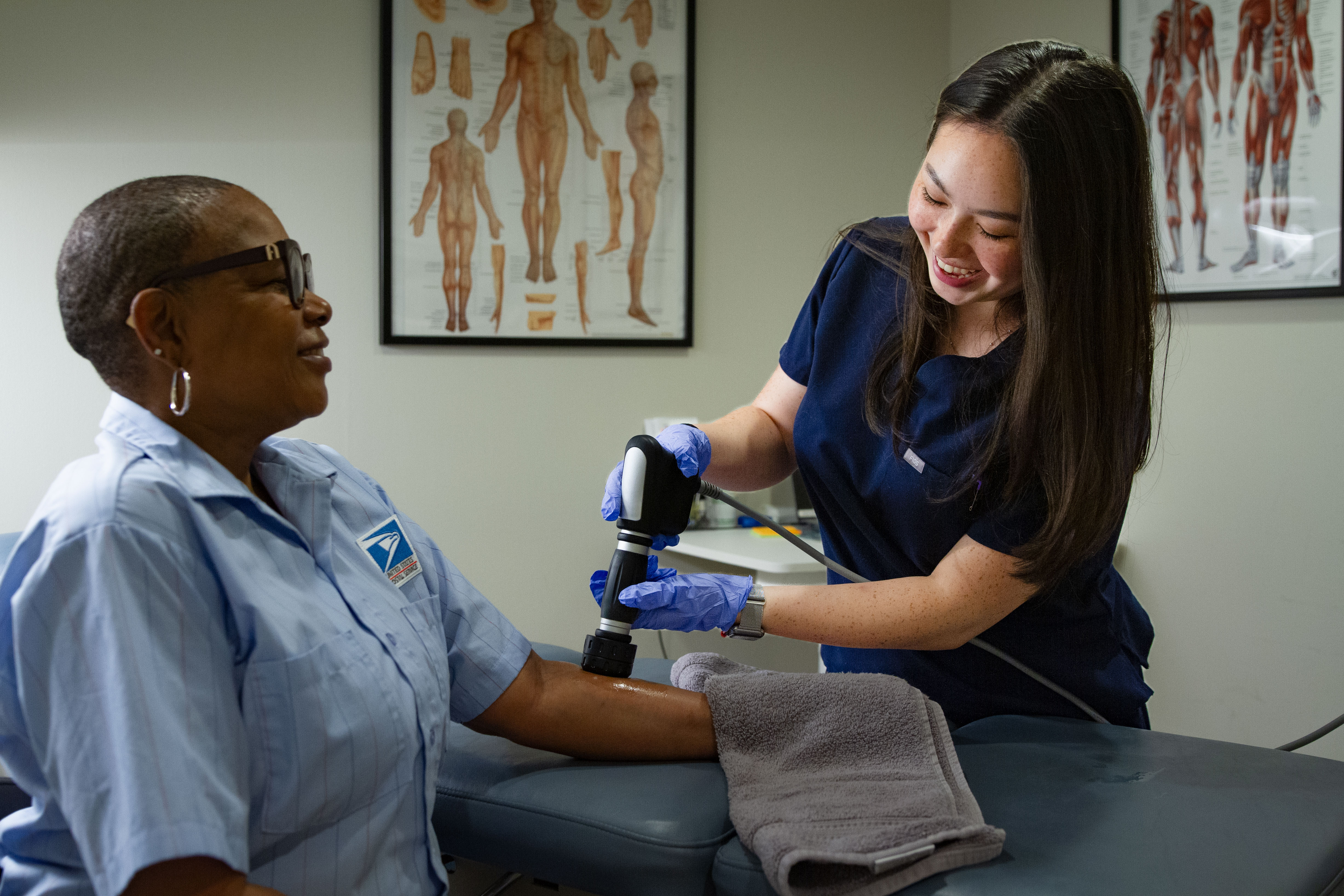Peak Performance clinical team providing advanced therapy to an injured USPS postal employee