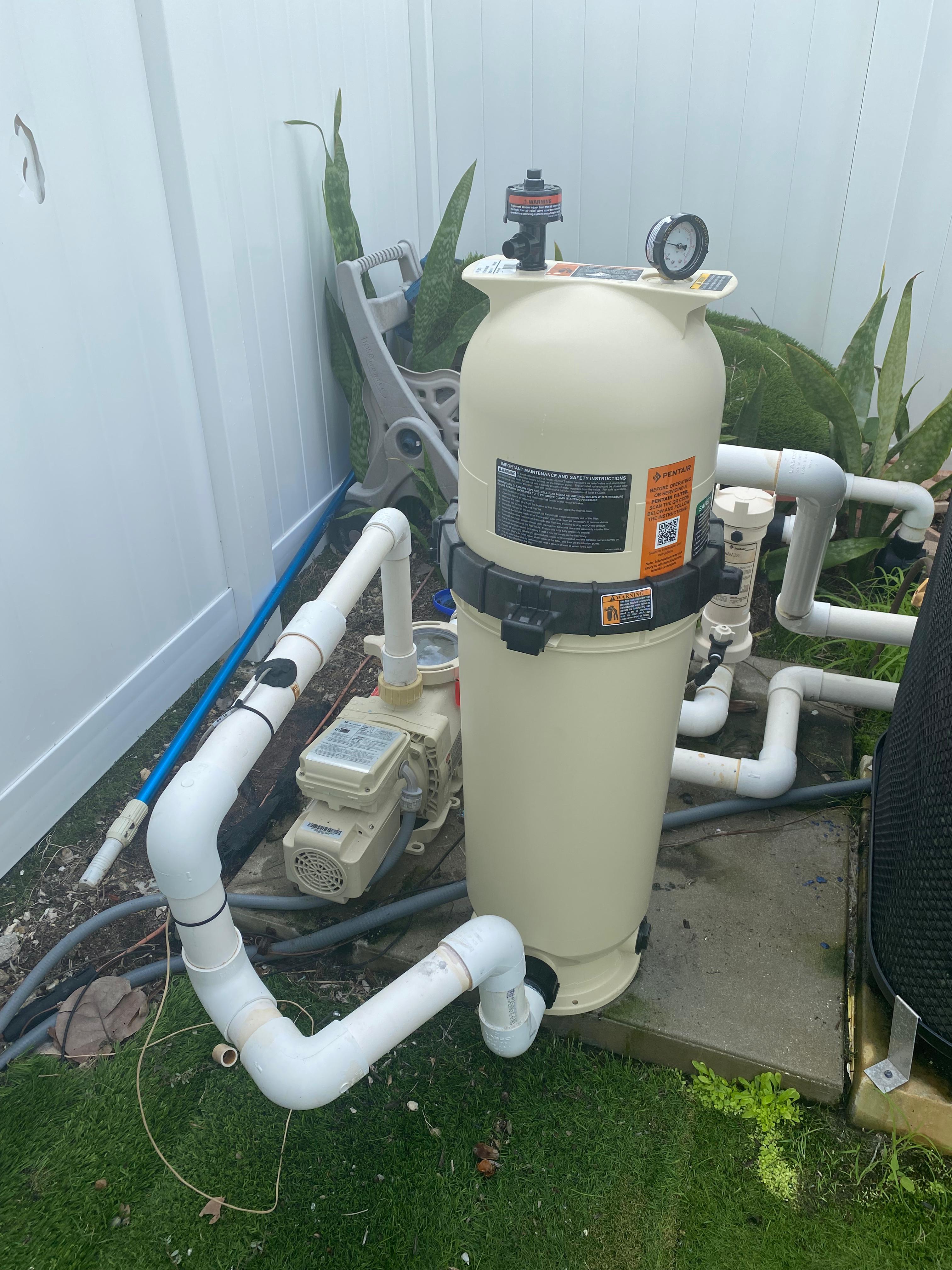Pentair residential cartridge pool filter system and pump on equipment pad