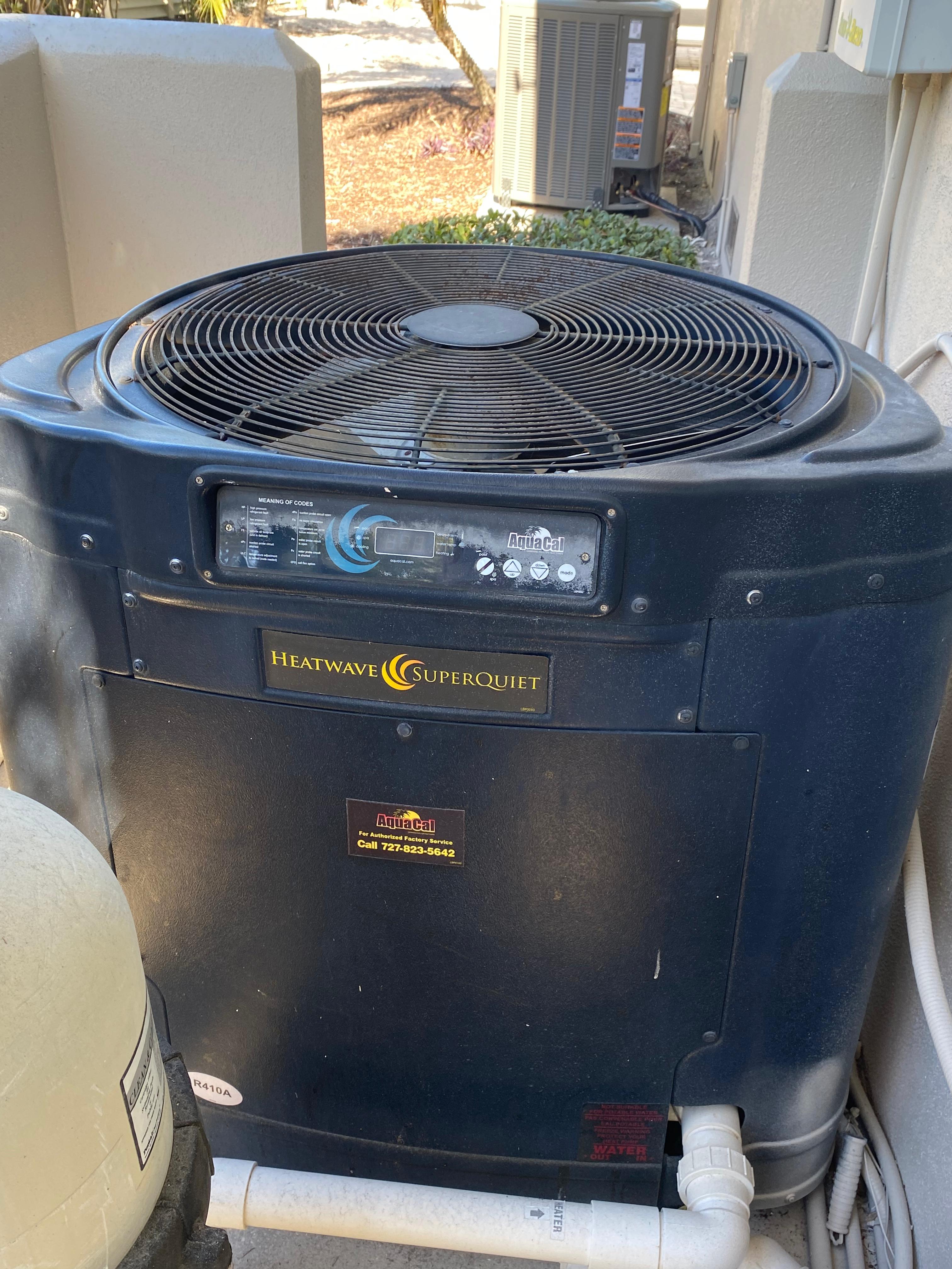 AquaCal Heatwave SuperQuiet residential electric pool heat pump installed on equipment pad