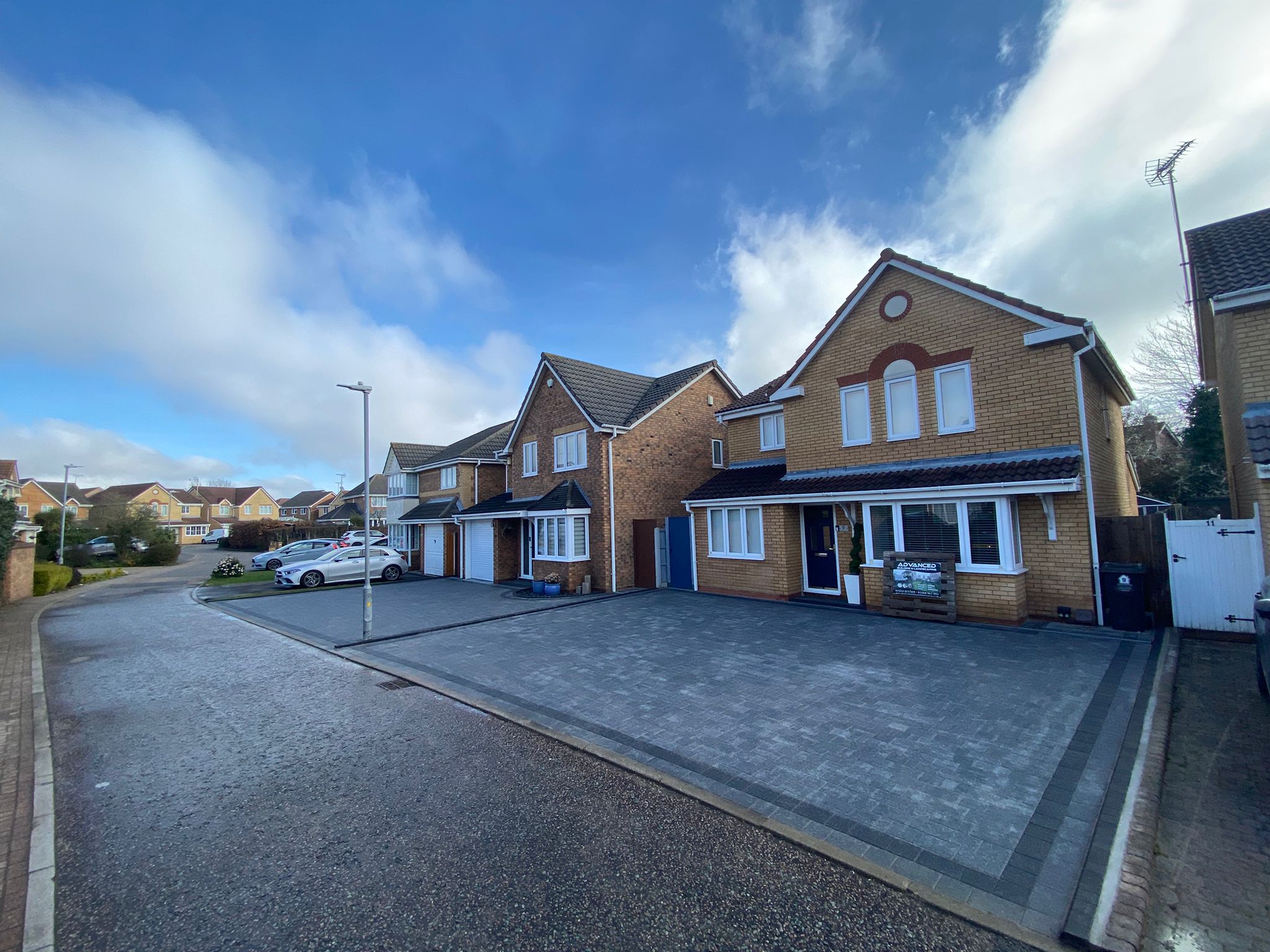 Modern grey block paved driveway installation across residential frontage in Essex
