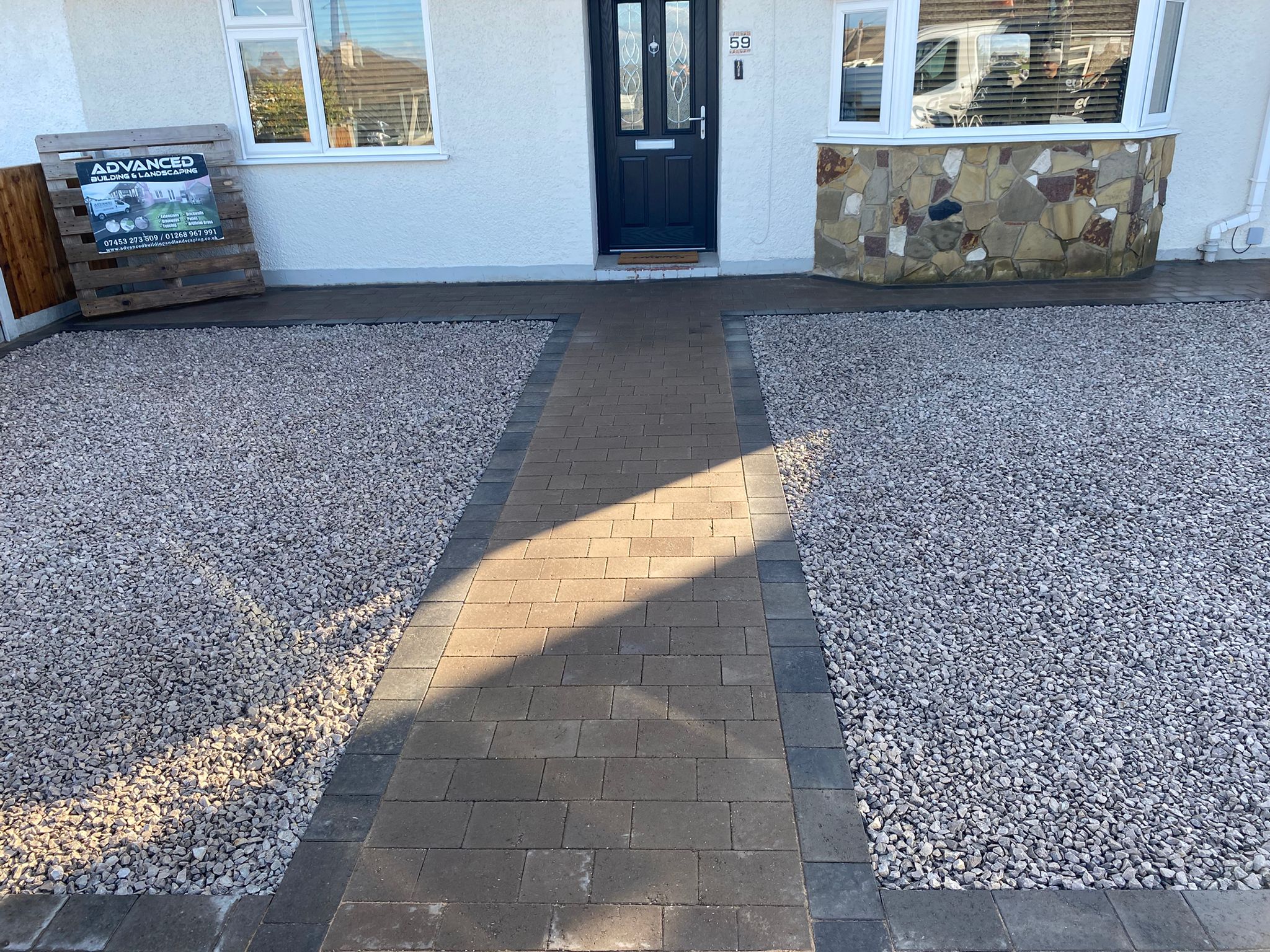 Block paved pathway detail leading through gravel driveway to front entrance
