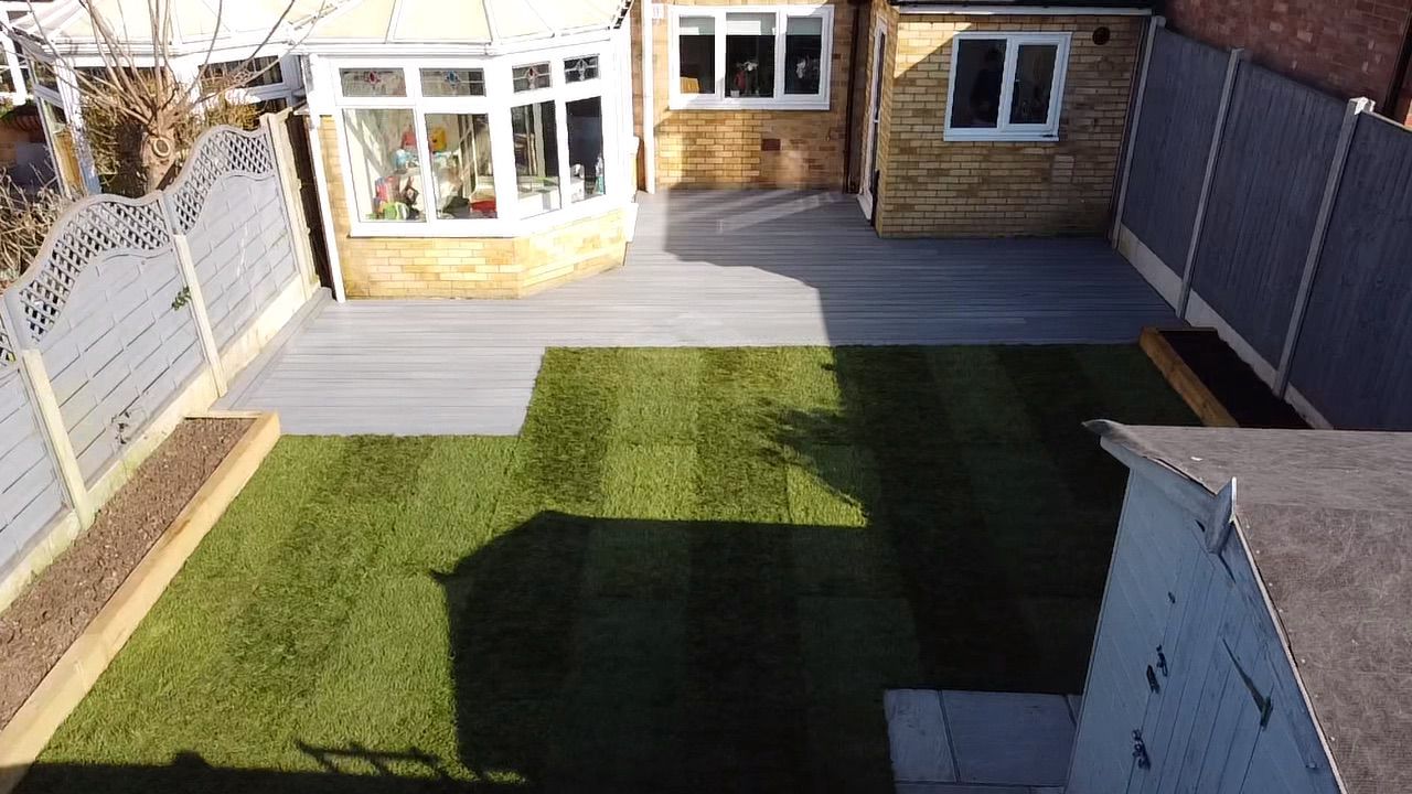 Grey decking area with manicured lawn and garden fencing in Essex