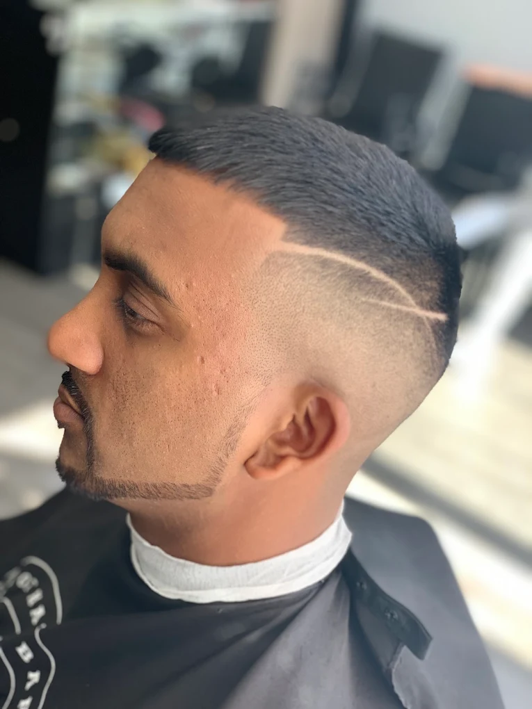 Buzz fade with razor part line & sharp beard lineup — House of Haze