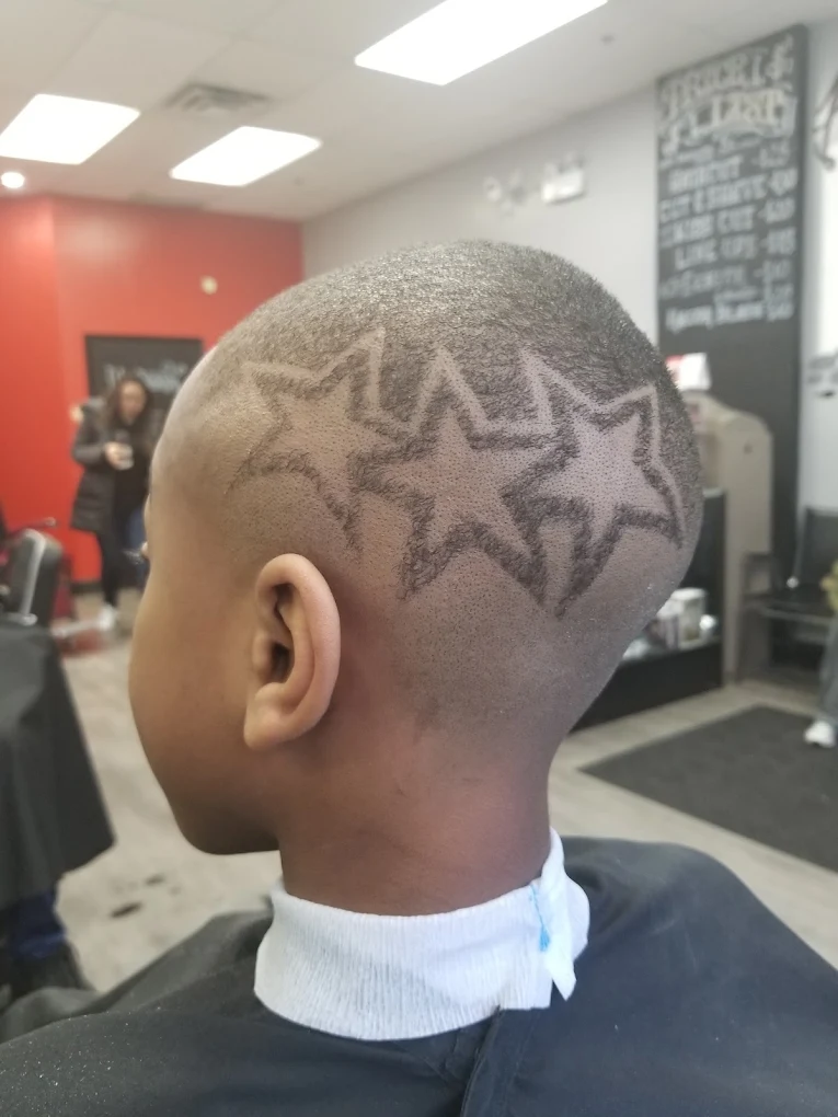 Custom star hair design with clean skin fade — House of Haze