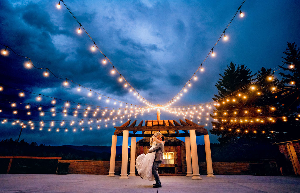 A romantic wedding celebration under string lights at Deer Creek Valley Ranch