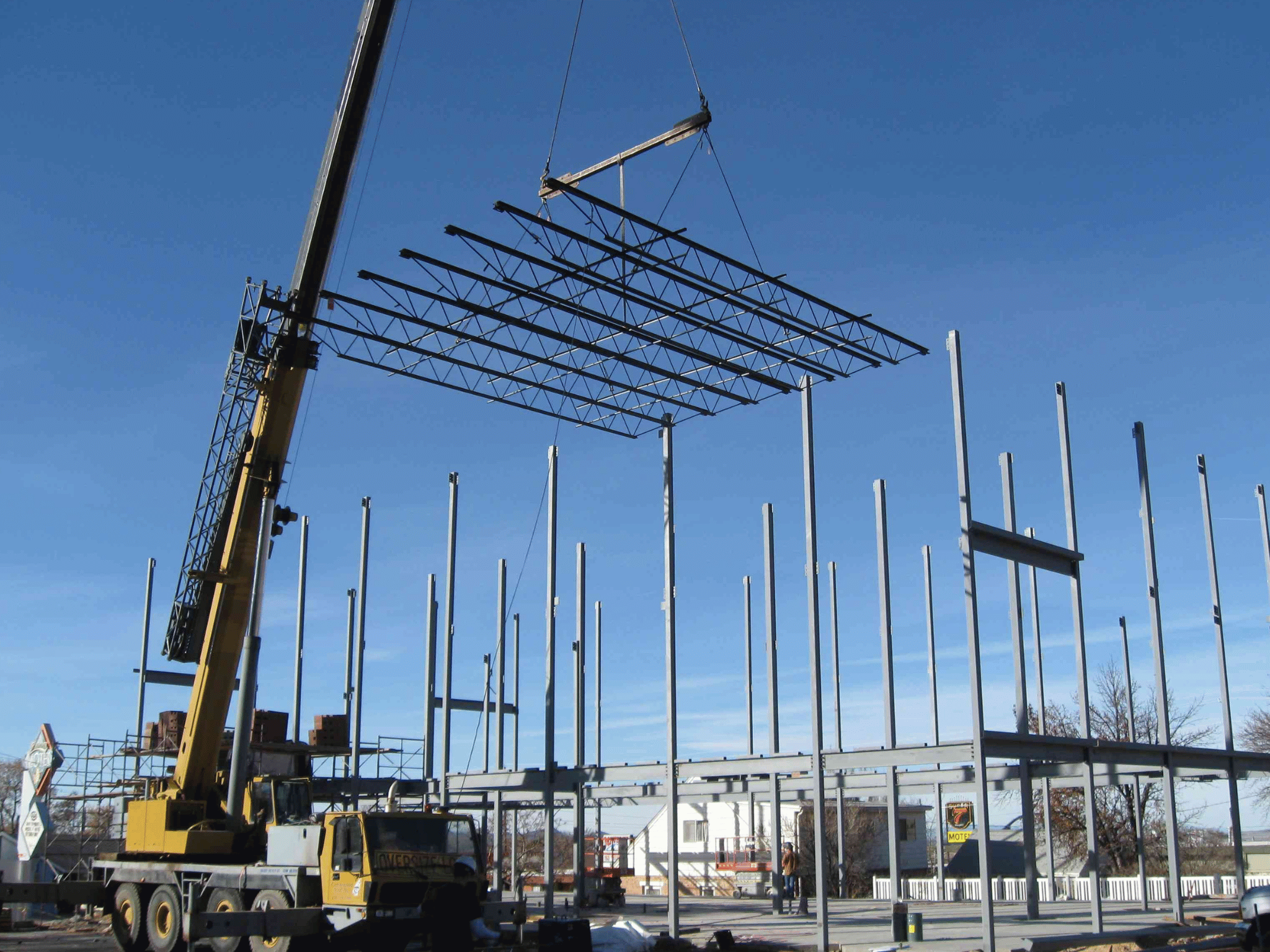 Mobile crane lifting roof truss grid during structural steel framing of Cedar Main Business Center