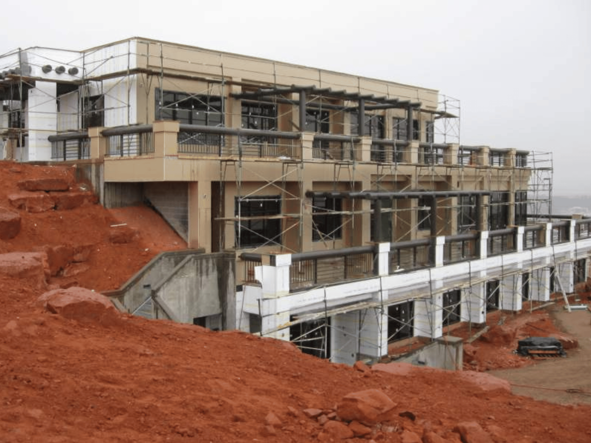 Exterior facade construction and scaffolding on hillside at Washington County Water Conservancy District building