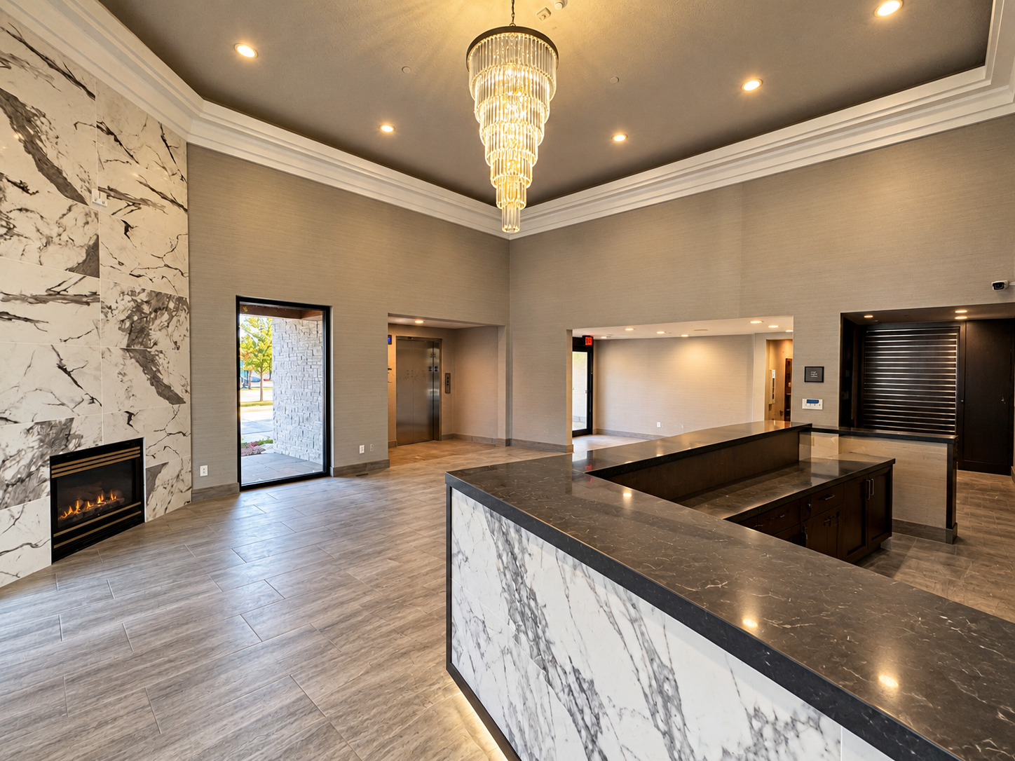 Newly renovated Abbey Inn lobby featuring bookmatched marble fireplace surround, crystal tier chandelier, and marble reception counter