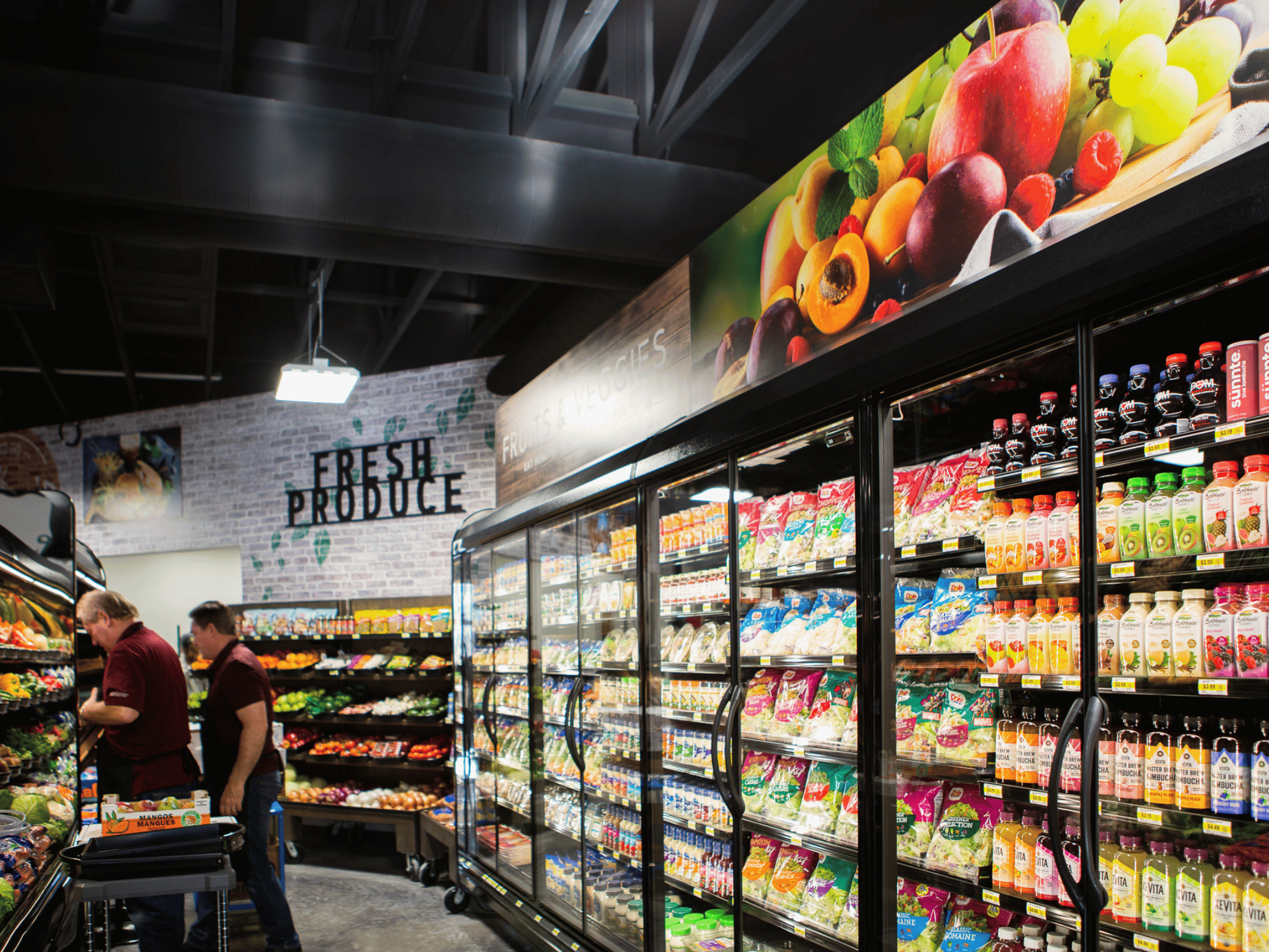 Foster's Market grocery interior with fresh produce section and commercial glass-door refrigerated cases