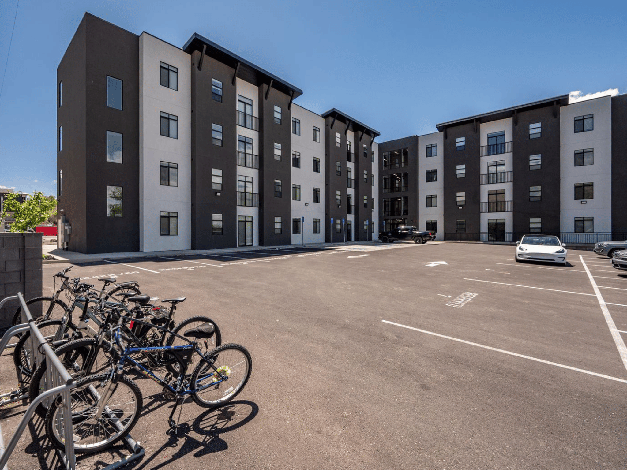 Building courtyard and resident parking area with bicycle racks and modern multi-story exterior