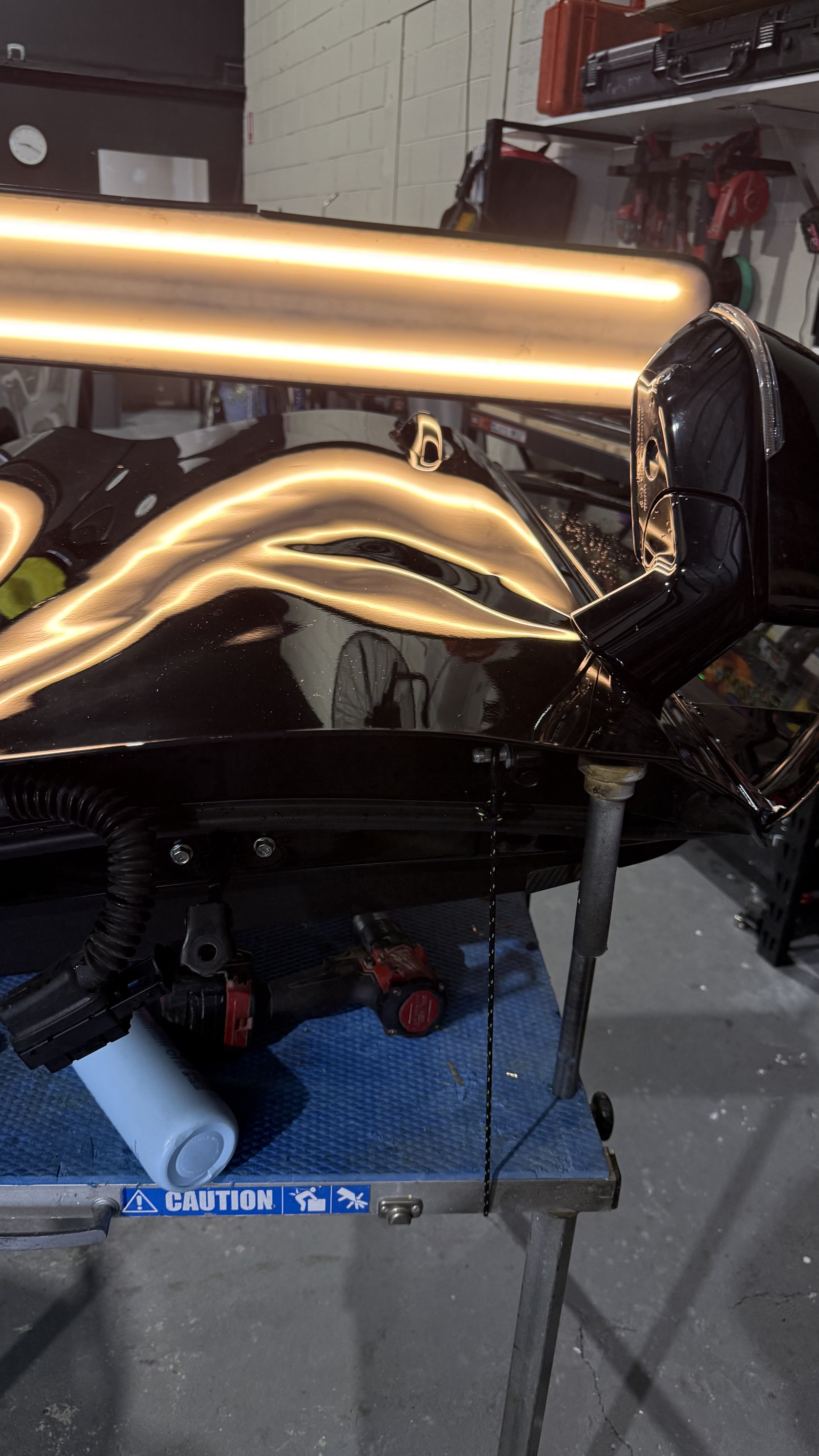 Black door panel mounted on specialised PDR stand under optical reflection light