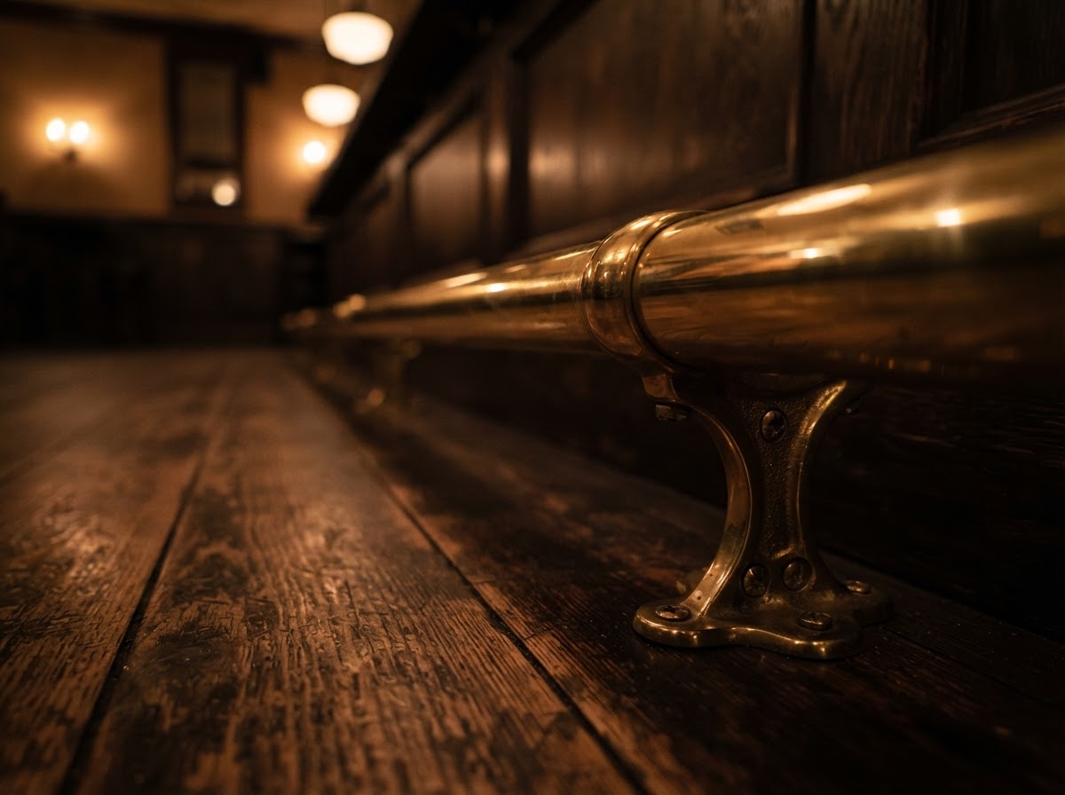 Close-up of a polished brass bar foot rail