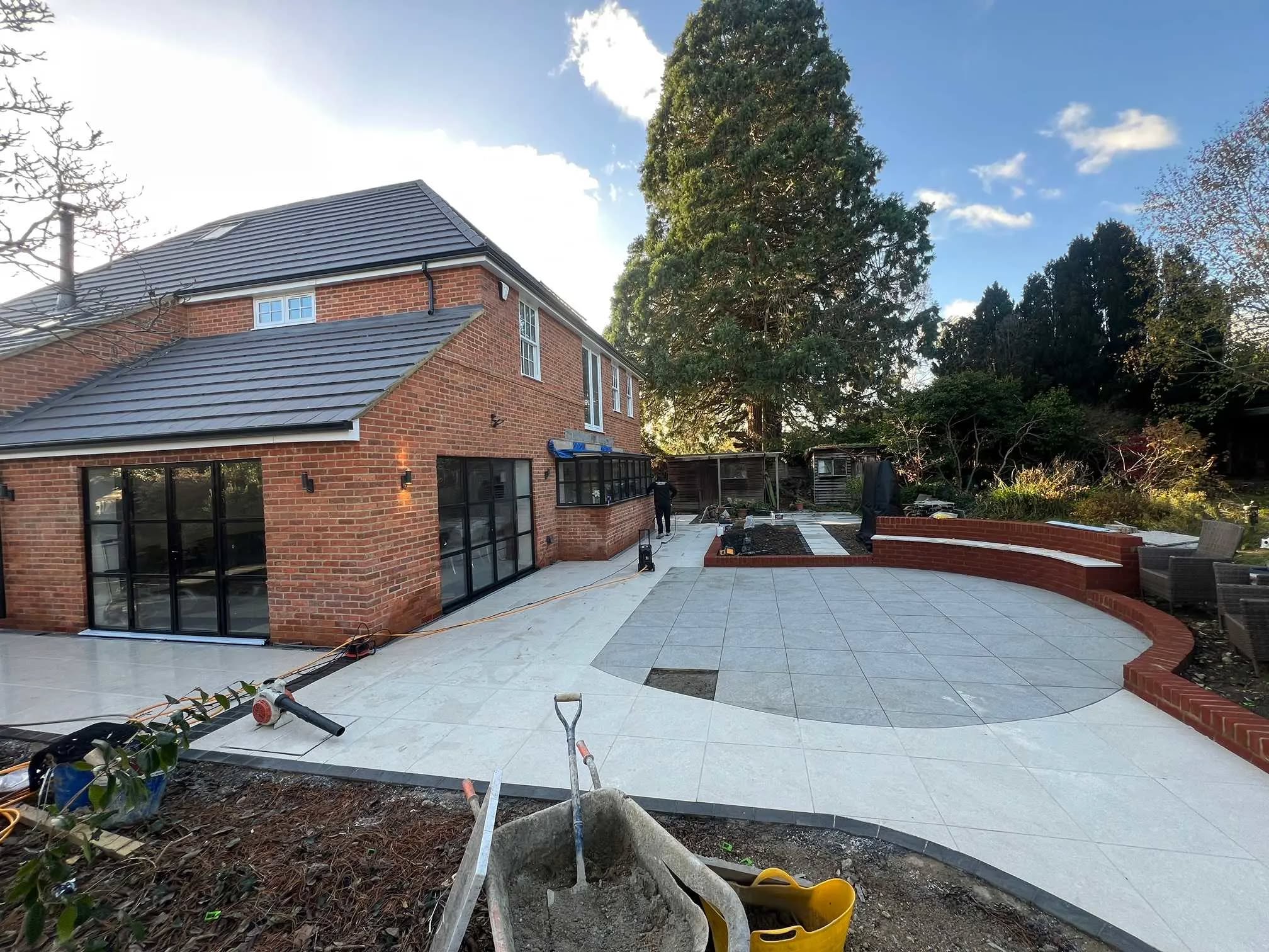 Modern home extension with brickwork and large patio doors by JCP Building Contractors