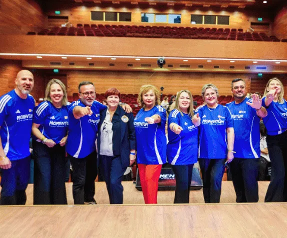 The team in Momentum shirts on stage in Bucharest