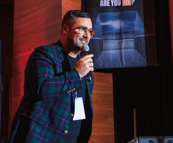 A speaker on stage at Momentum