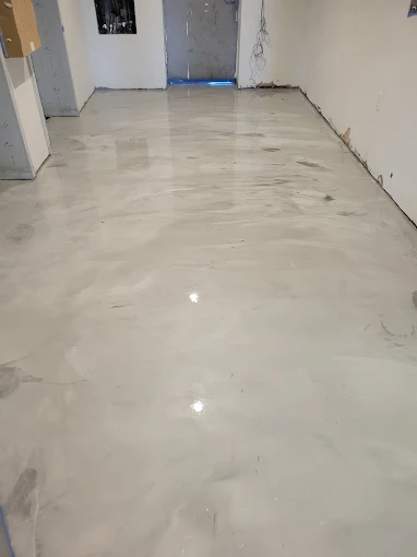 Hudson Epoxy Flooring completed light gray and white glossy reflective interior concrete floor with fluid movement