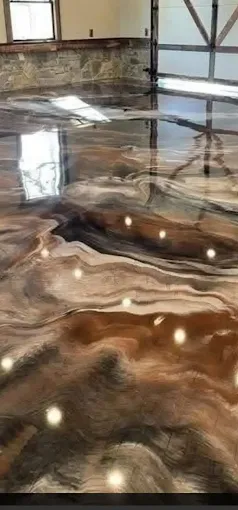 Hudson Epoxy Flooring completed rich brown and bronze high-gloss metallic floor with warm liquid ribbon swirl patterns reflecting windows and lighting