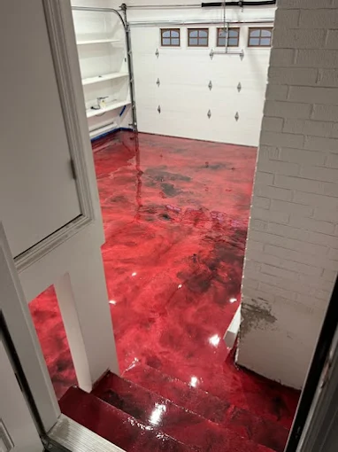 Hudson Epoxy Flooring completed red and black metallic garage floor with high-gloss finish and entryway steps