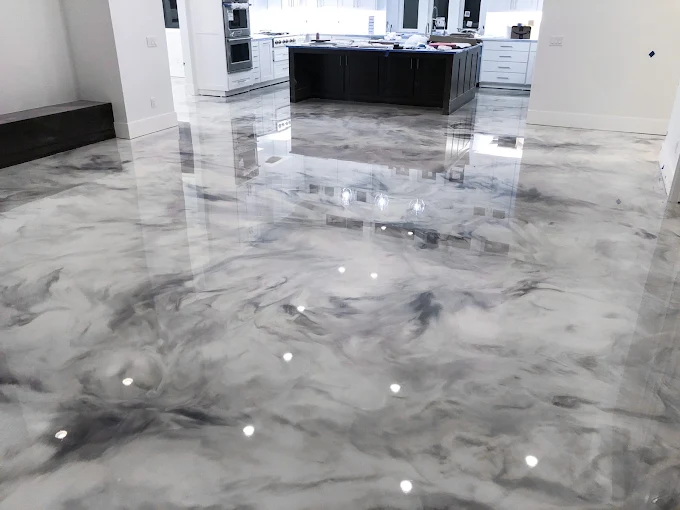 Hudson Epoxy Flooring completed white and gray marble-effect high-gloss metallic floor reflecting kitchen cabinetry and island