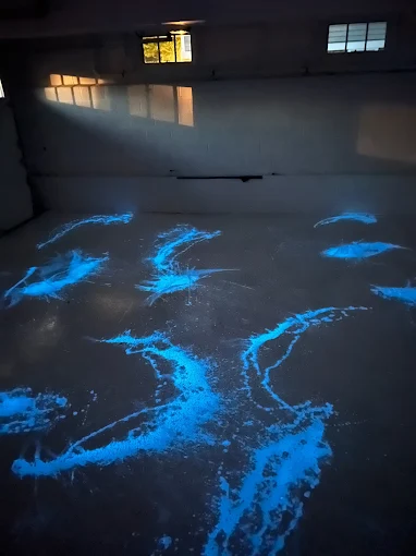 Hudson Epoxy Flooring completed dark floor with vivid luminous electric blue splash effects across the interior