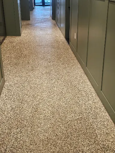 Hudson Epoxy Flooring completed light decorative flake floor coating with seamless coverage down hallway