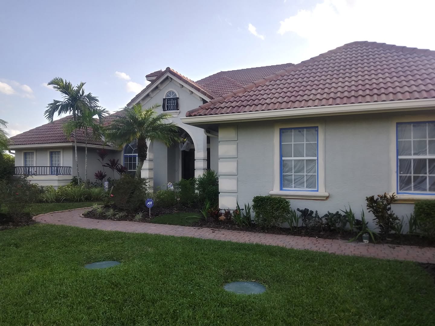 Mediterranean tile-roof villa in Naples taped and prepped for exterior stucco painting