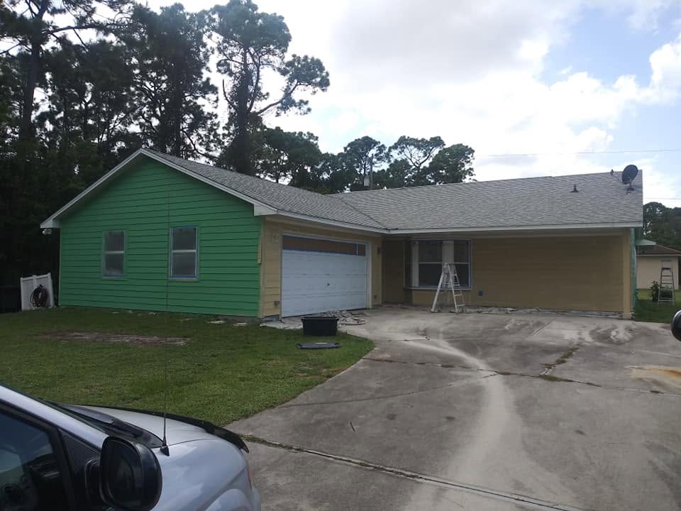 Bonita Springs home exterior siding undergoing color transformation to coastal green