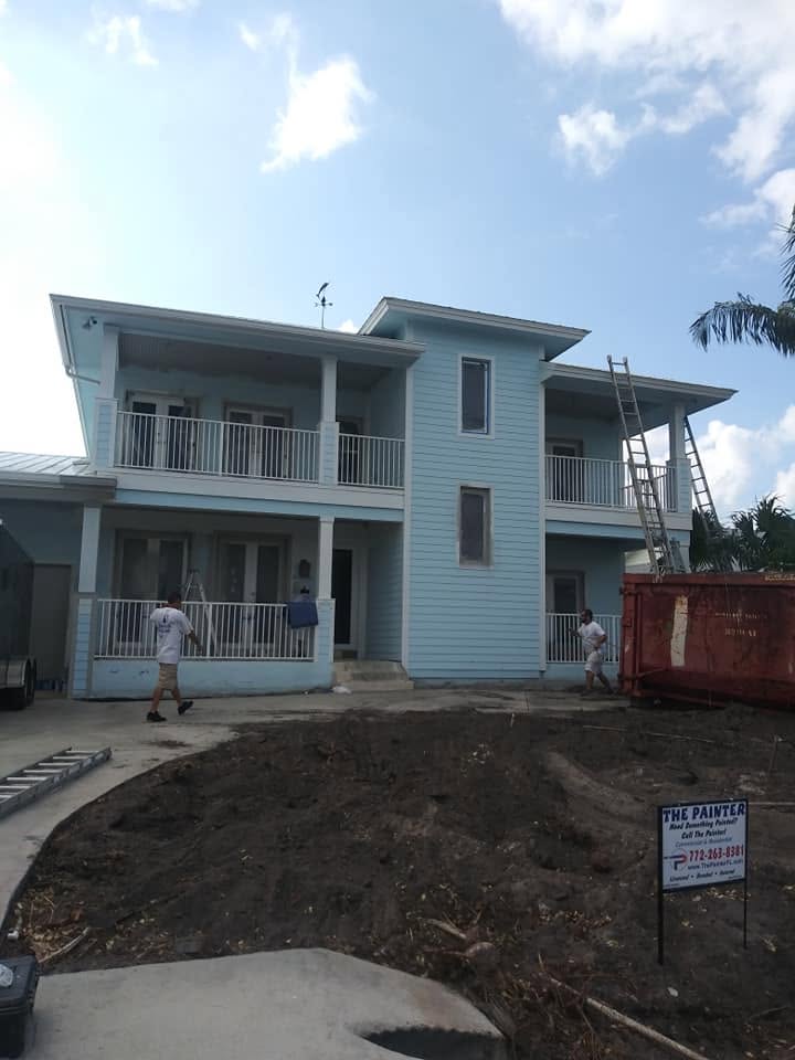 Two-story coastal Naples home exterior siding, second-story balconies, and white trim