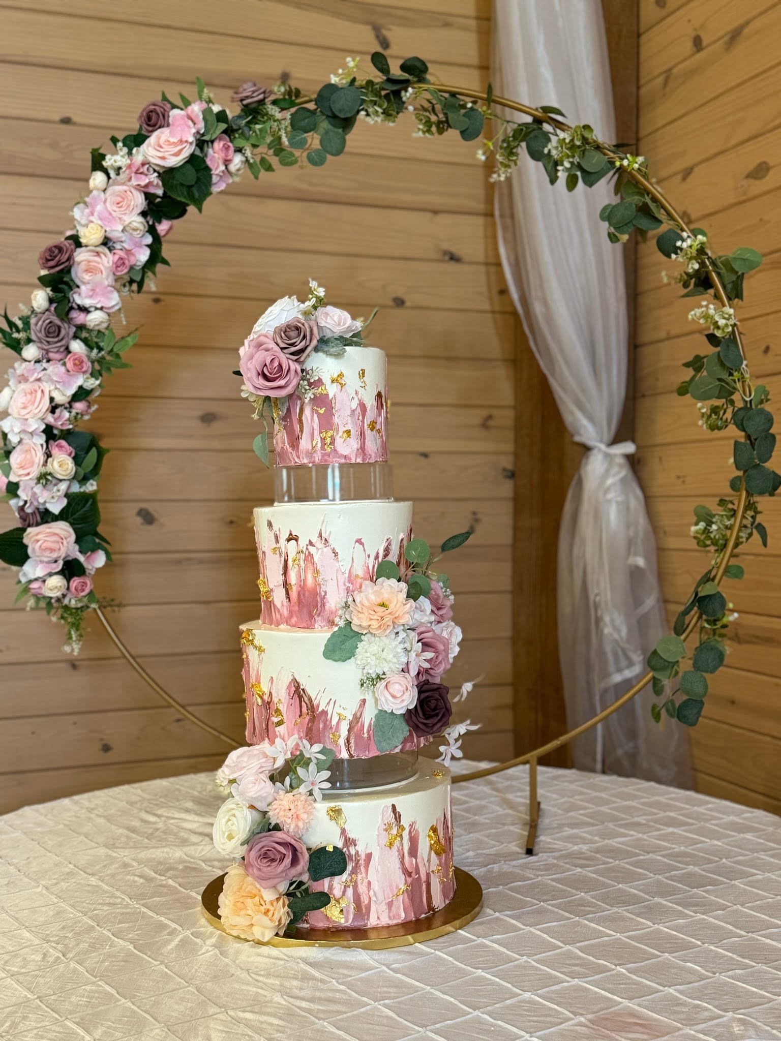 Premium tiered wedding cake with gold foil and hand-painted accents