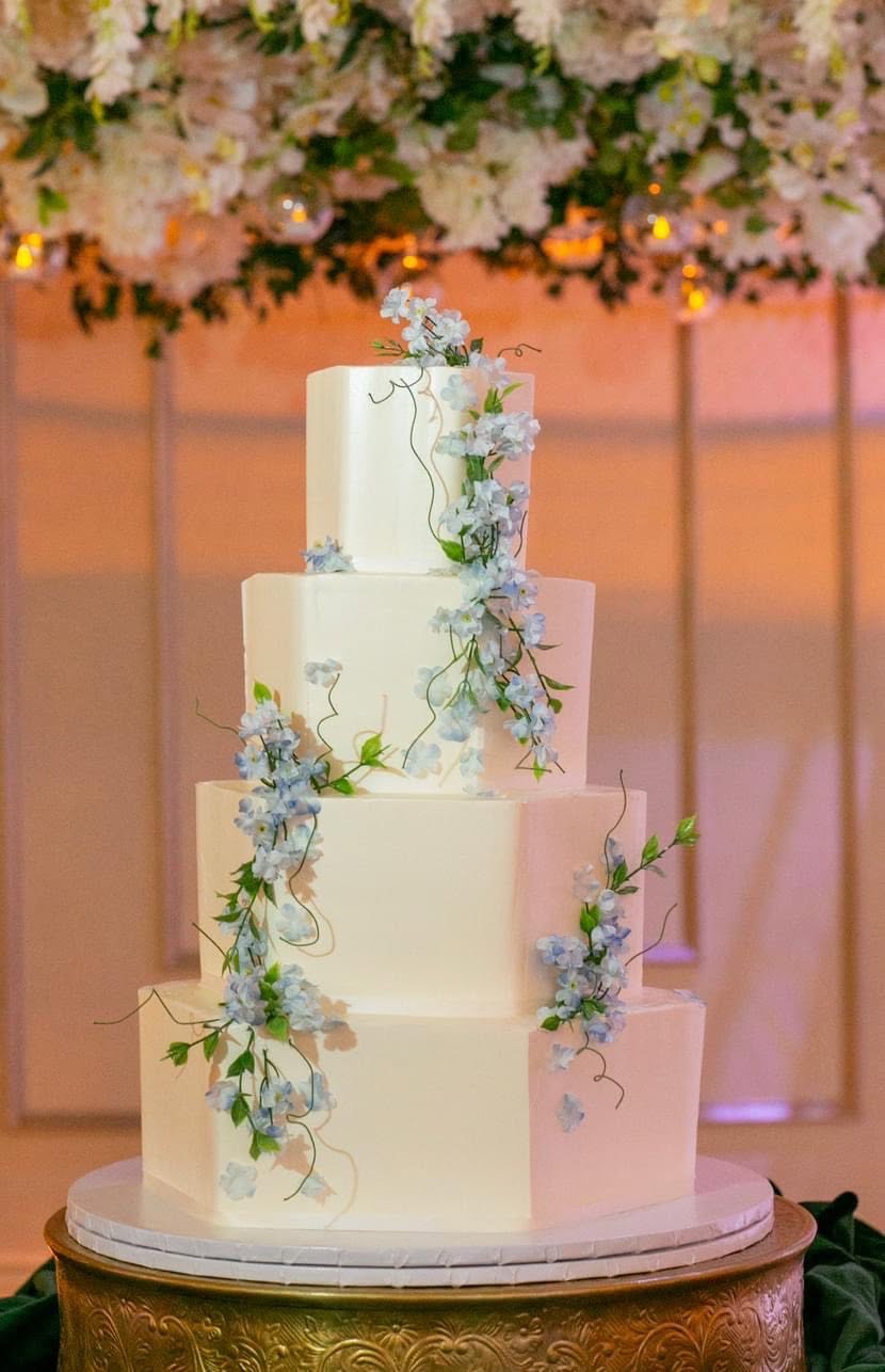 Handcrafted Swiss Meringue Buttercream cake with delicate blue florals