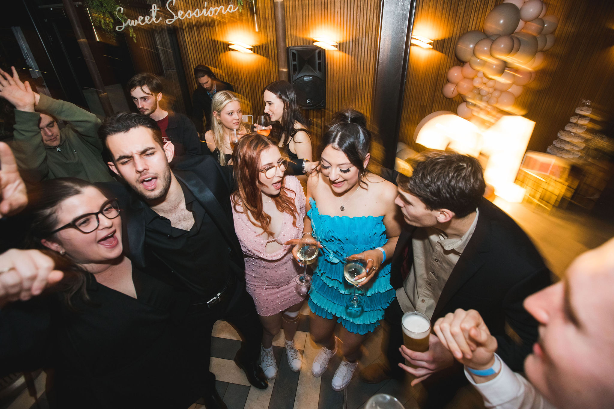 A 21st birthday crowd lit by colourful wash lighting at a Diesel Productions private event in Perth