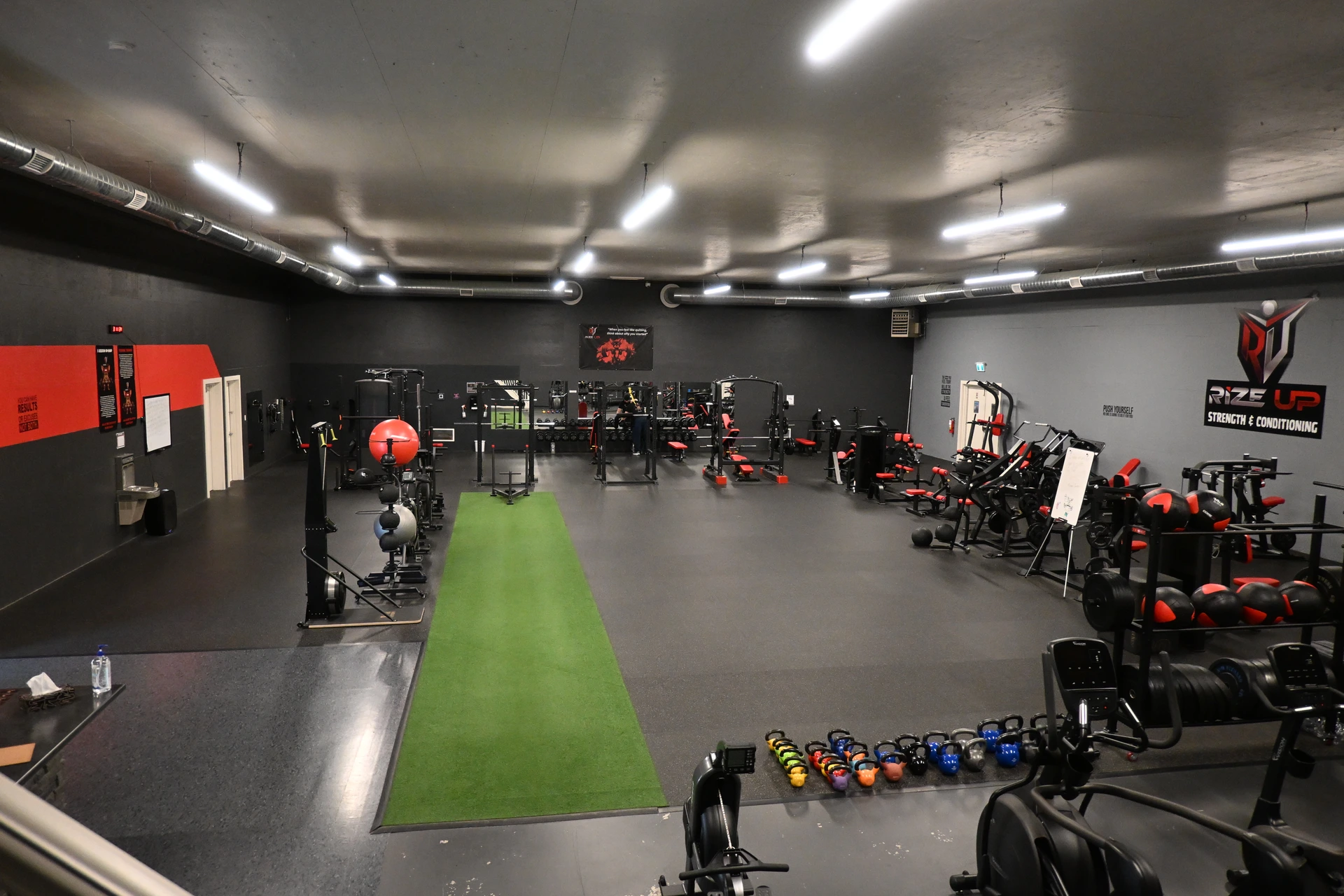 Rize Up Strength and Conditioning indoor facility training floor, turf, and equipment