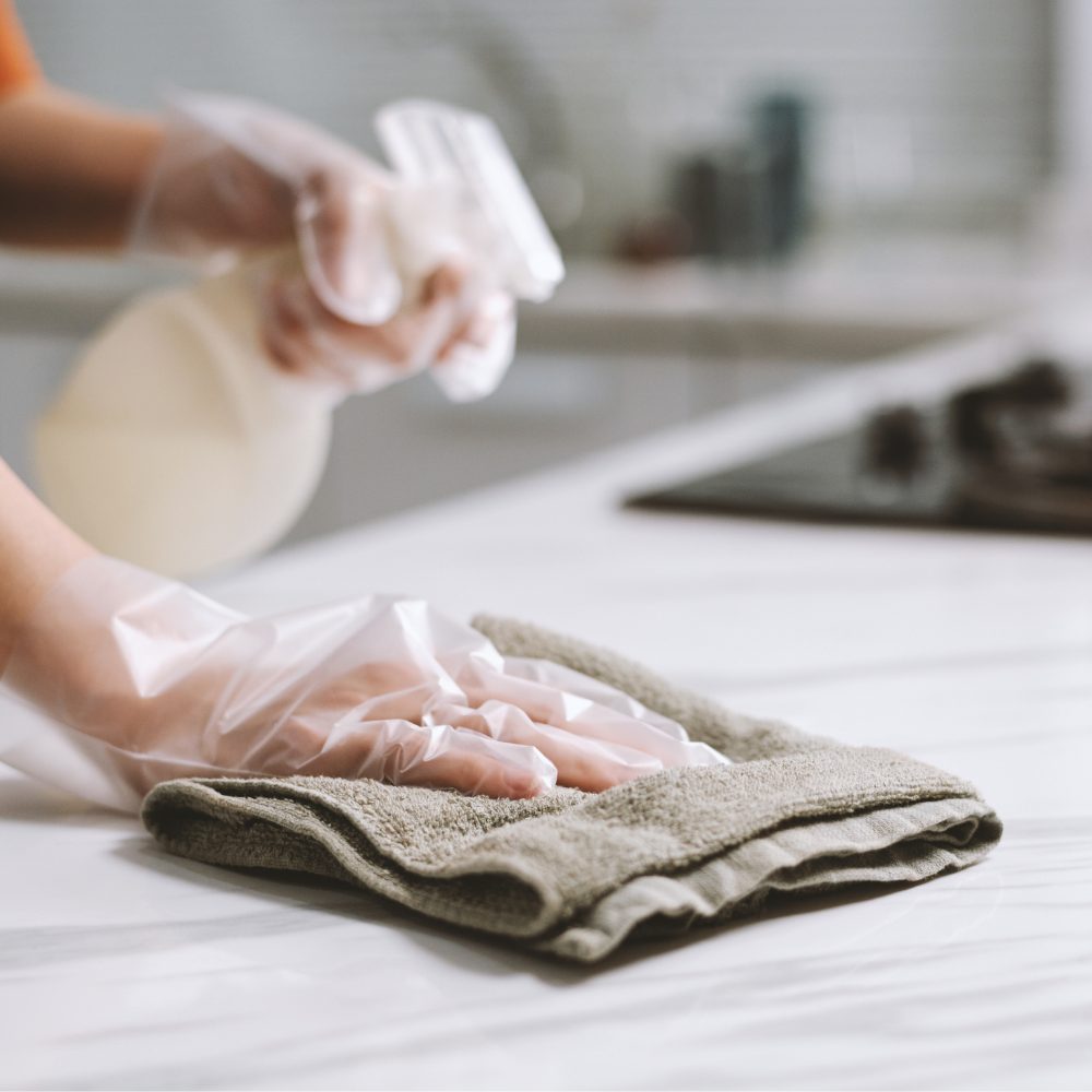 Cleaner wiping a kitchen counter