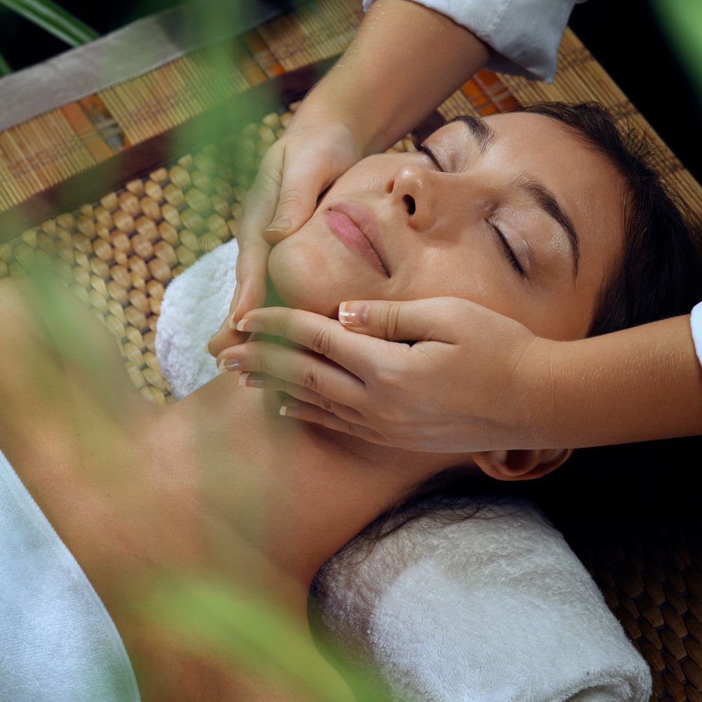 Spa therapist giving a facial massage