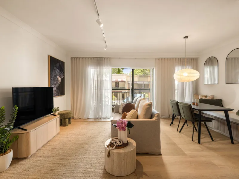Surry Hills renovated open-plan living room with light timber floors, sheer curtains and modern dining suite