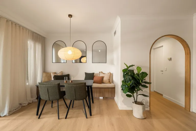 Surry Hills dining nook with built-in banquette bench seating, three arched wall mirrors and paper lantern pendant