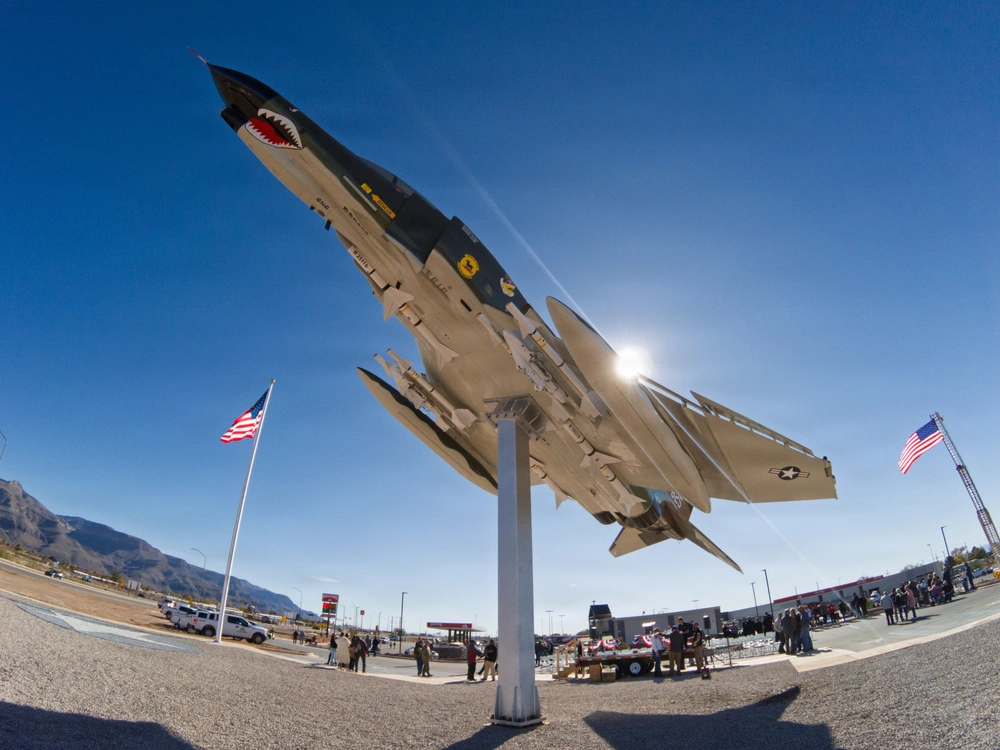The Gateway Freedom Monument in Alamogordo, an F-4 Phantom II mounted against a clear desert sky, commemorating the ties between Holloman Air Force Base and the Tularosa Basin