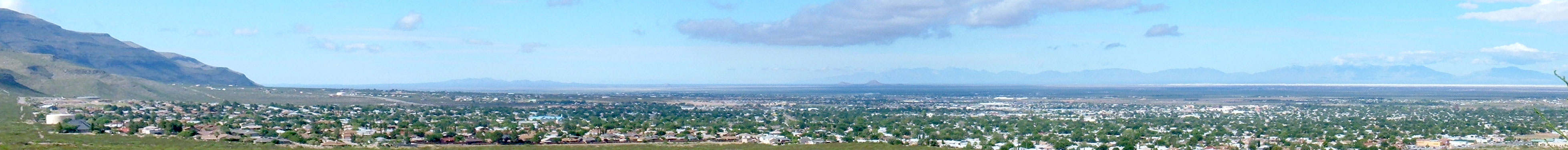 Panoramic view across Alamogordo, New Mexico, with the Sacramento Mountains to the left and the Tularosa Basin stretching east