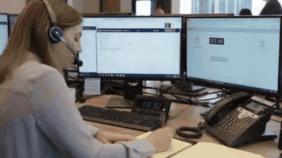 An intake agent on a headset passing a call on, and an attorney answering it at his desk