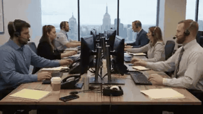 An intake team on calls at a row of desks