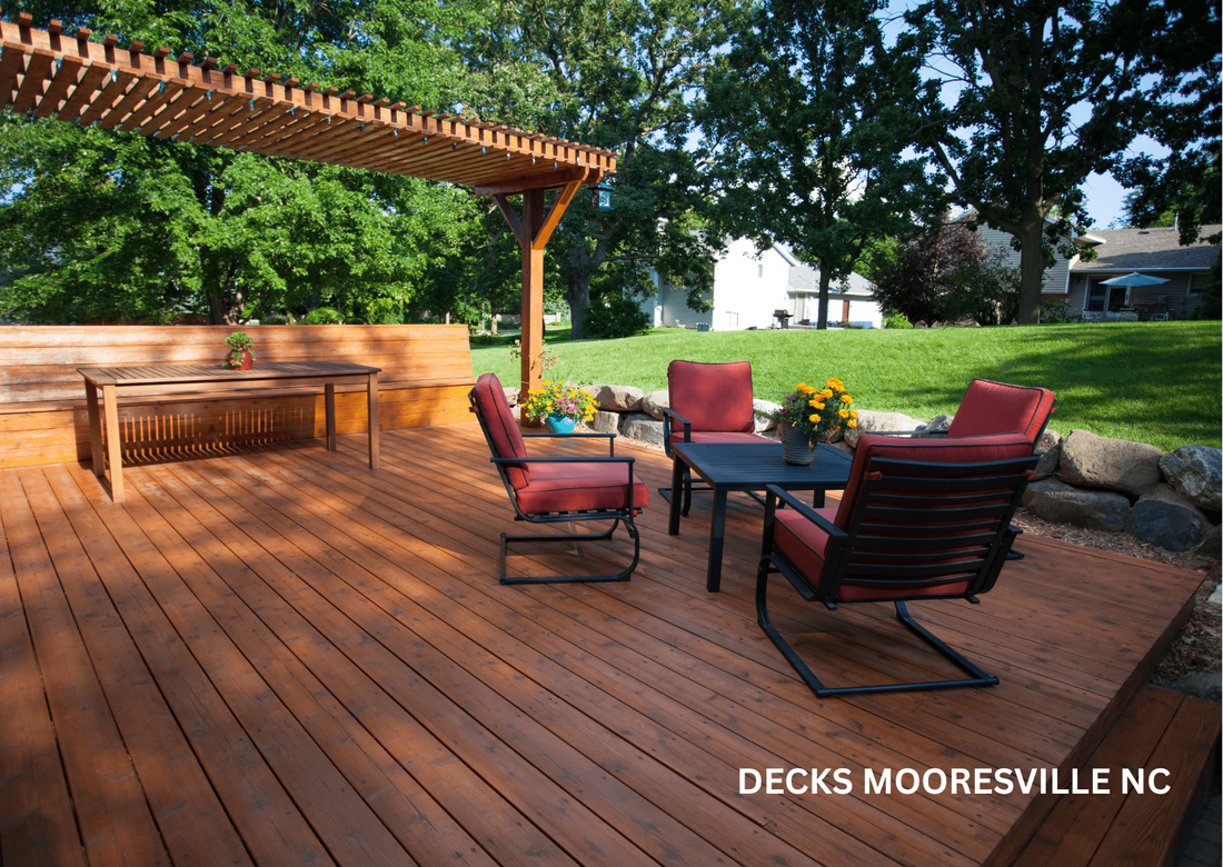 Wooden deck with four red chairs and a table and on the side another wooden table with a garden in the background