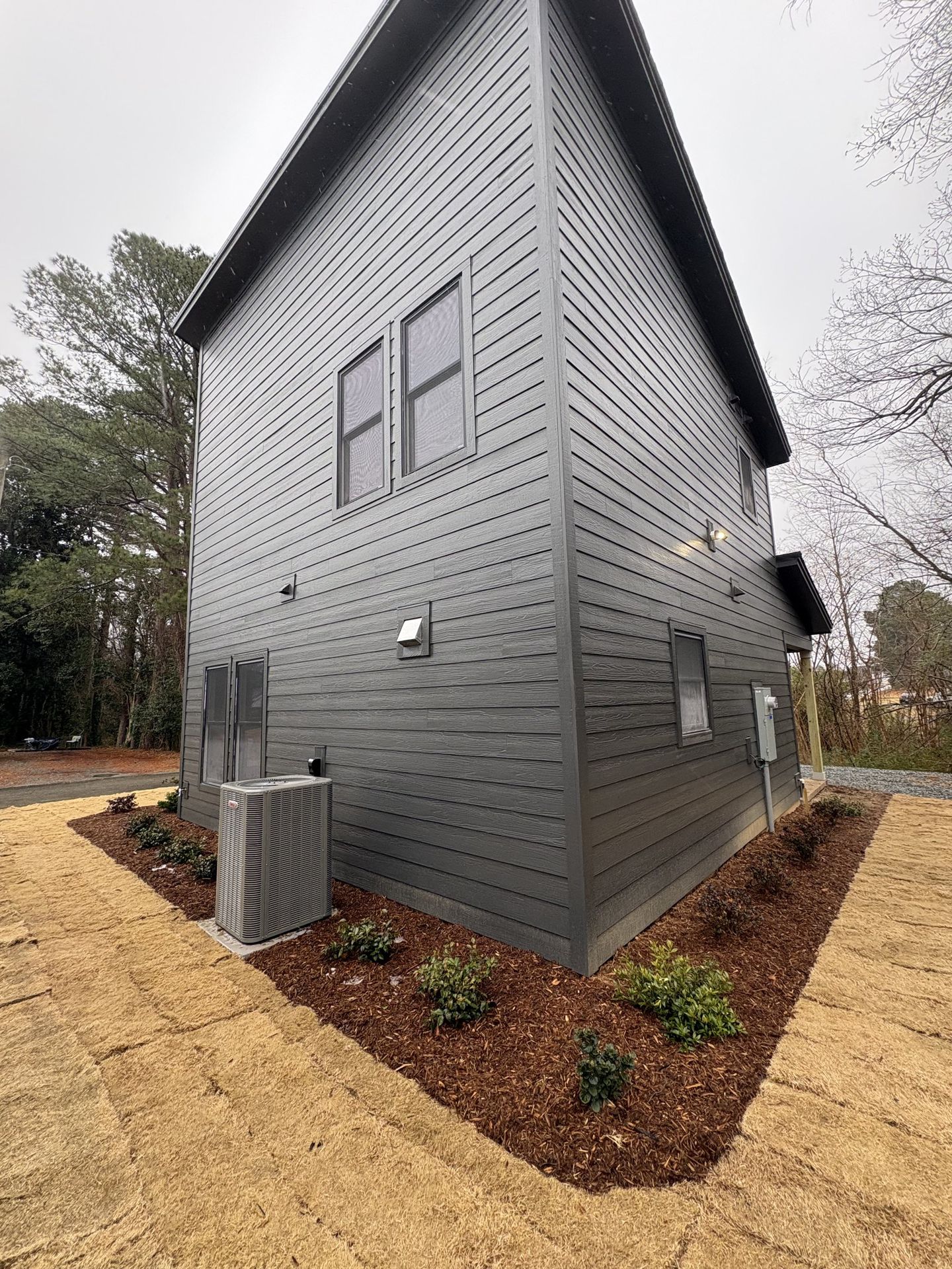 Modern exterior side view with black board and batten siding