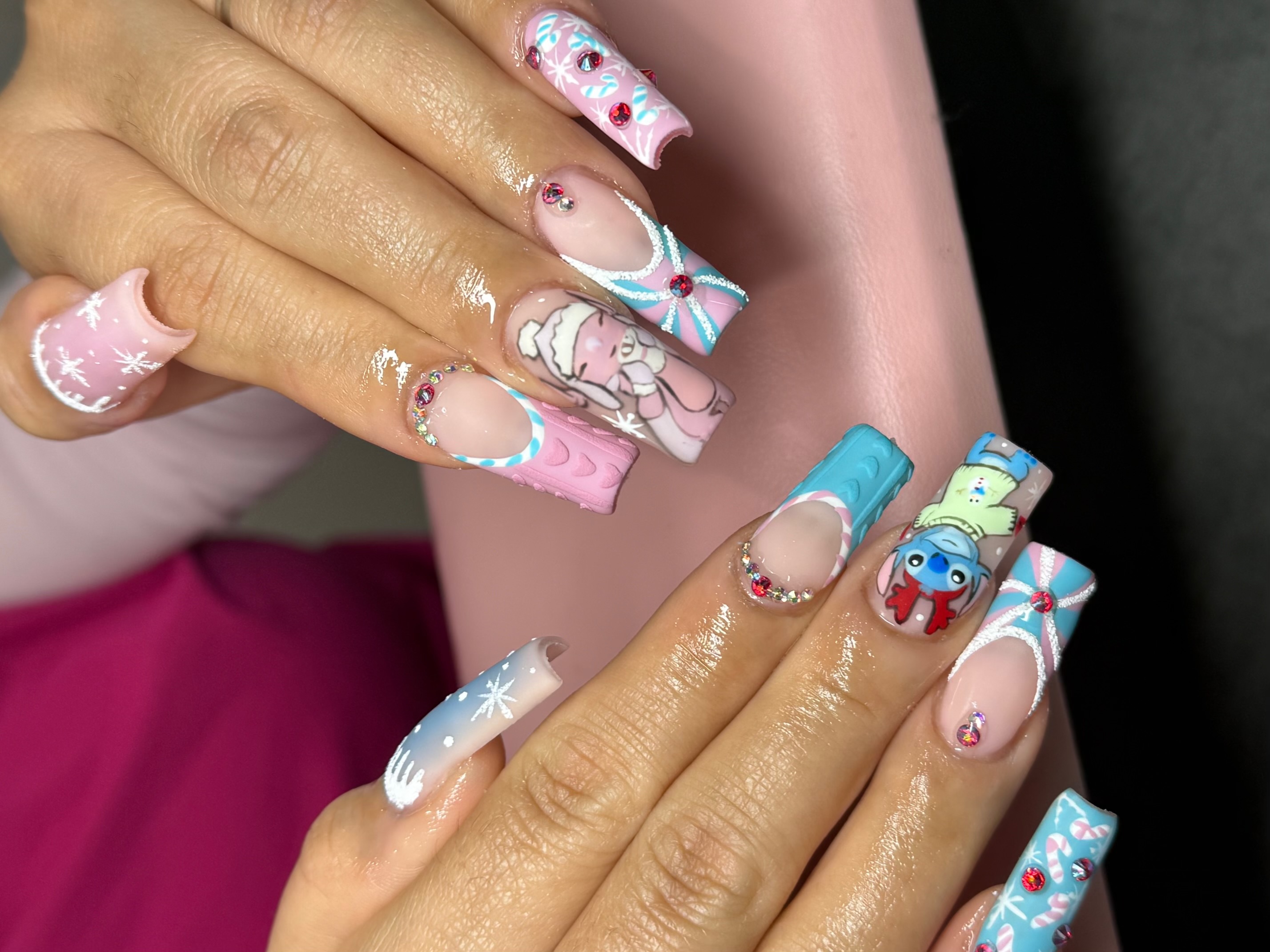 Long square nails featuring Stitch and Angel character art with 3D sweater knit texture and holiday candy cane french tips