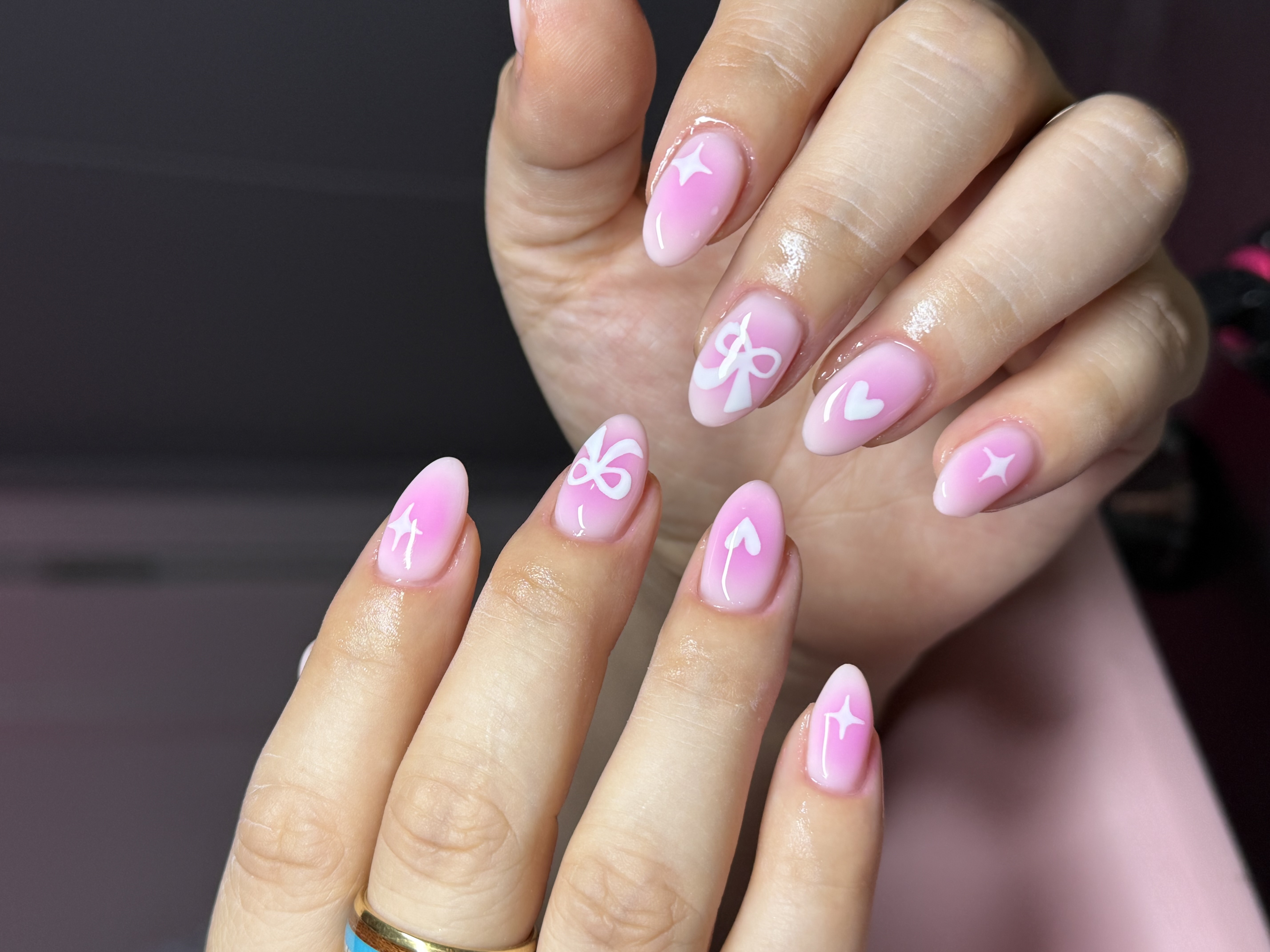 Elegant soft pink manicure resting on blush silk fabric