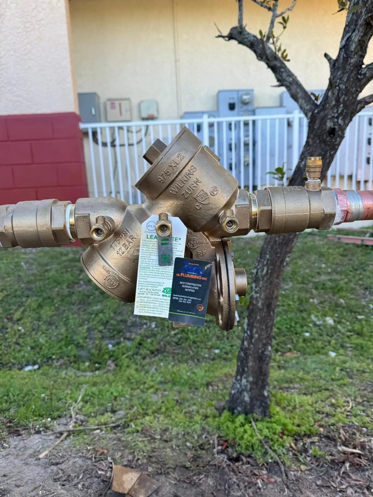 Zurn Wilkins backflow prevention assembly with Shaddai HL Plumbing company tag