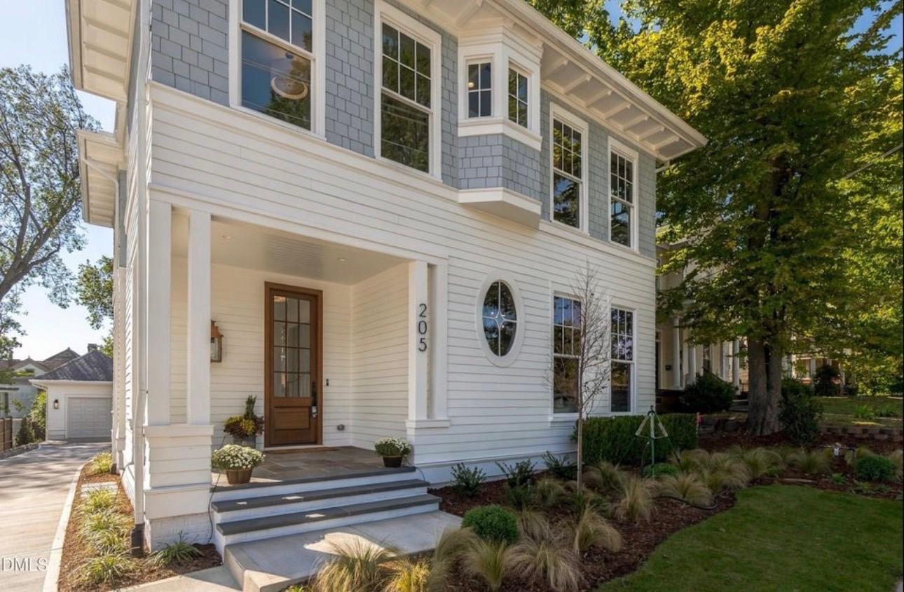 Classic Raleigh craftsman-inspired home with front porch, shake siding accents, and manicured landscaping