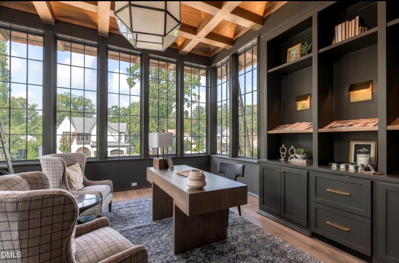 Custom home study in Raleigh with floor-to-ceiling multi-pane black windows, coffered ceiling, and custom charcoal built-ins